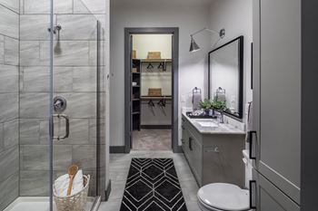 Aura thirty2 new apartments in austin, texas model bathroom with attached walk-in closet